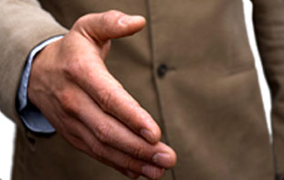 A man in brown jacket holding out his hand.