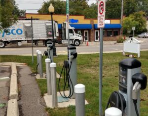 A row of electric car charging stations on the side of a road.